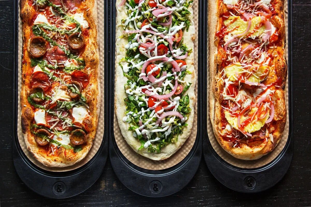 Three &pizza pies with a variety of toppings
